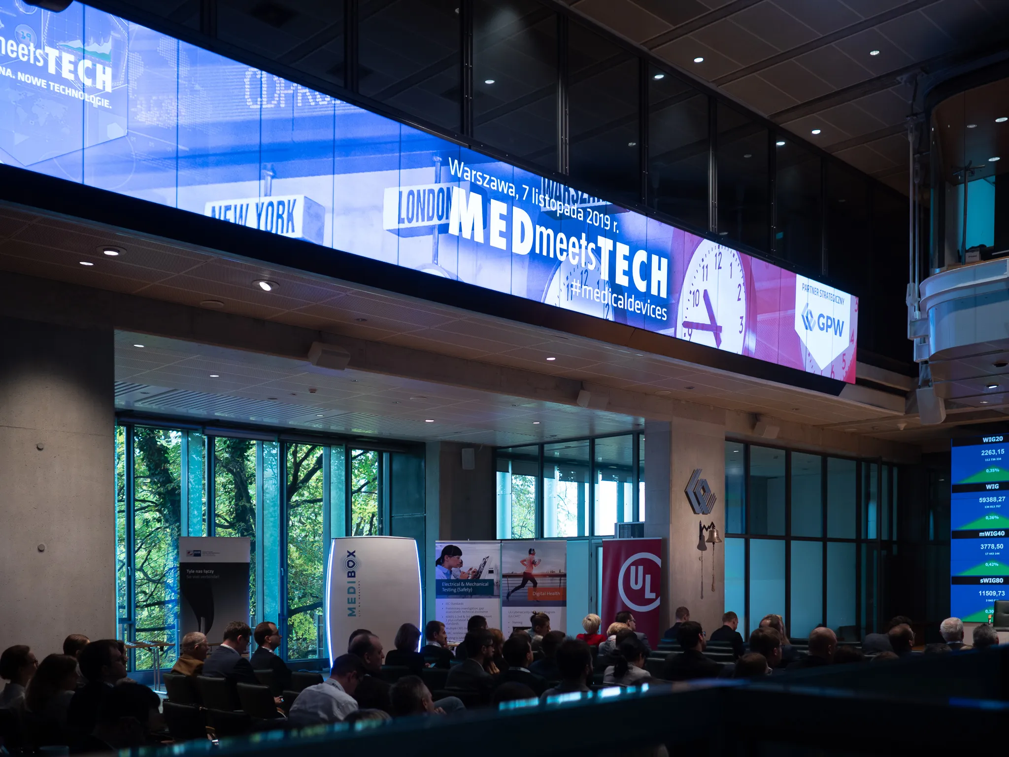 An audience gathers beneath a large Med Meets Tech banner at the Warsaw Stock Exchange.