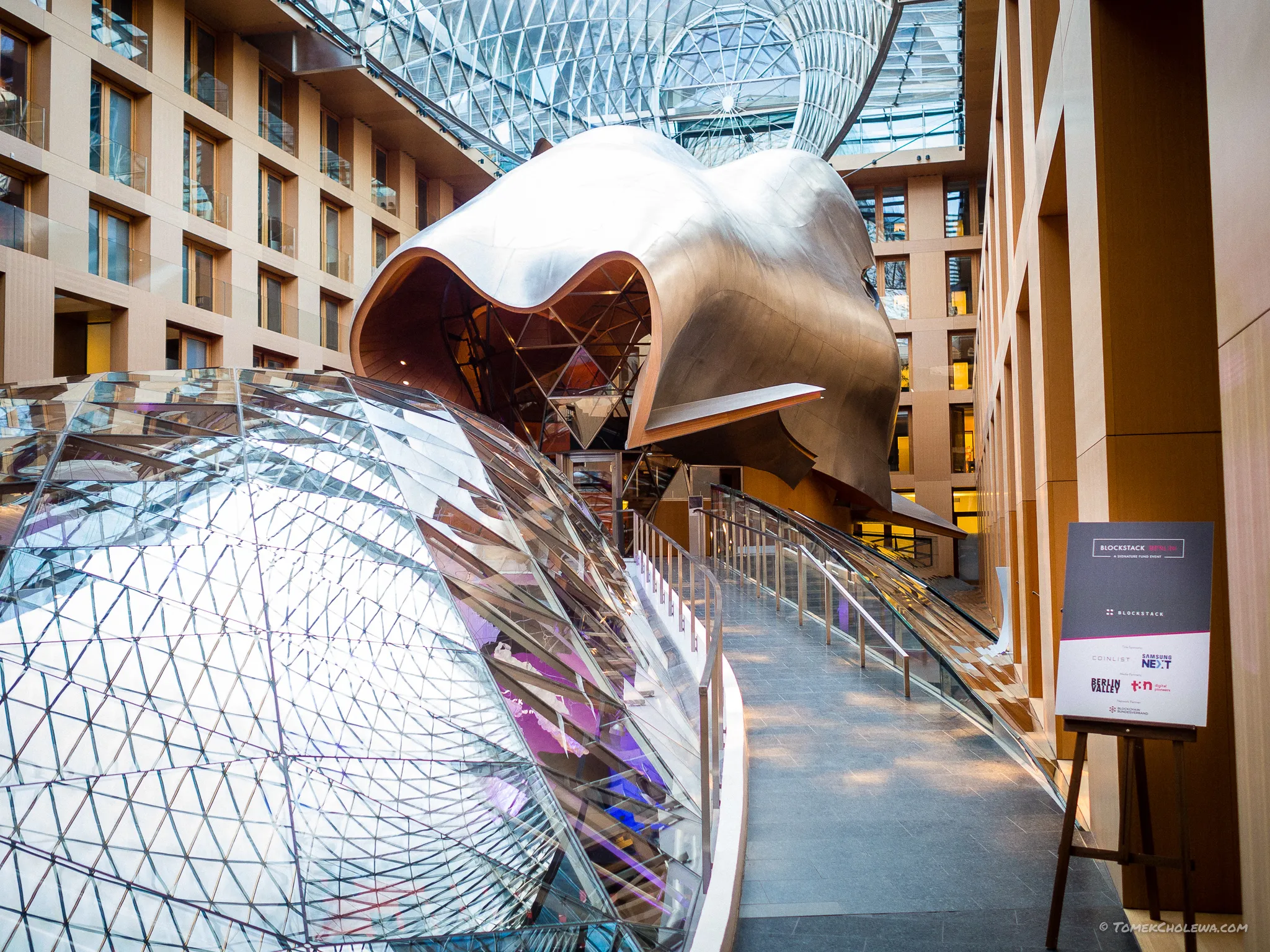 Sculptural metal and glass architecture inside the Blockstack Berlin venue.