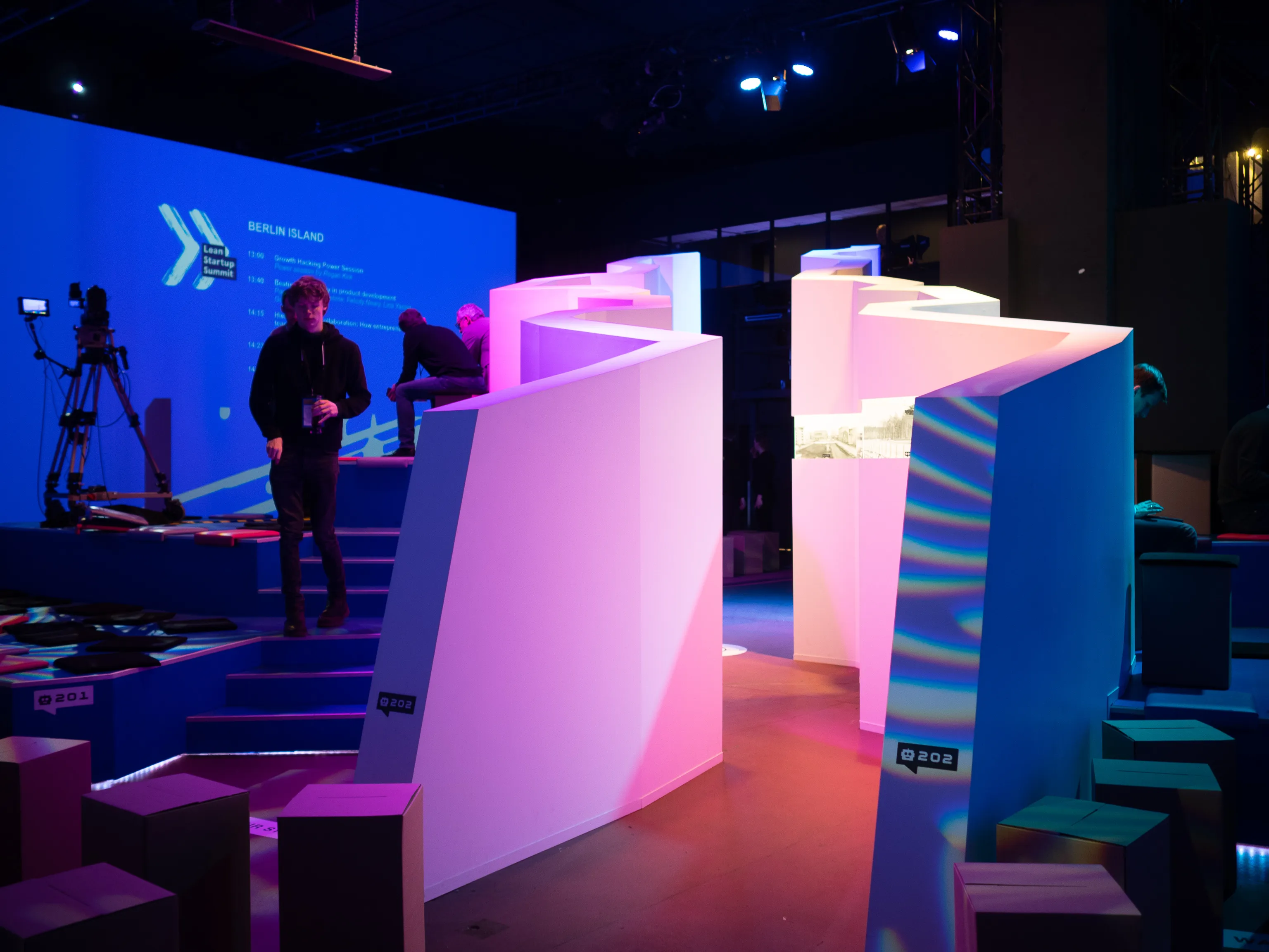 Crew members prepare a colorful geometric maze installation.